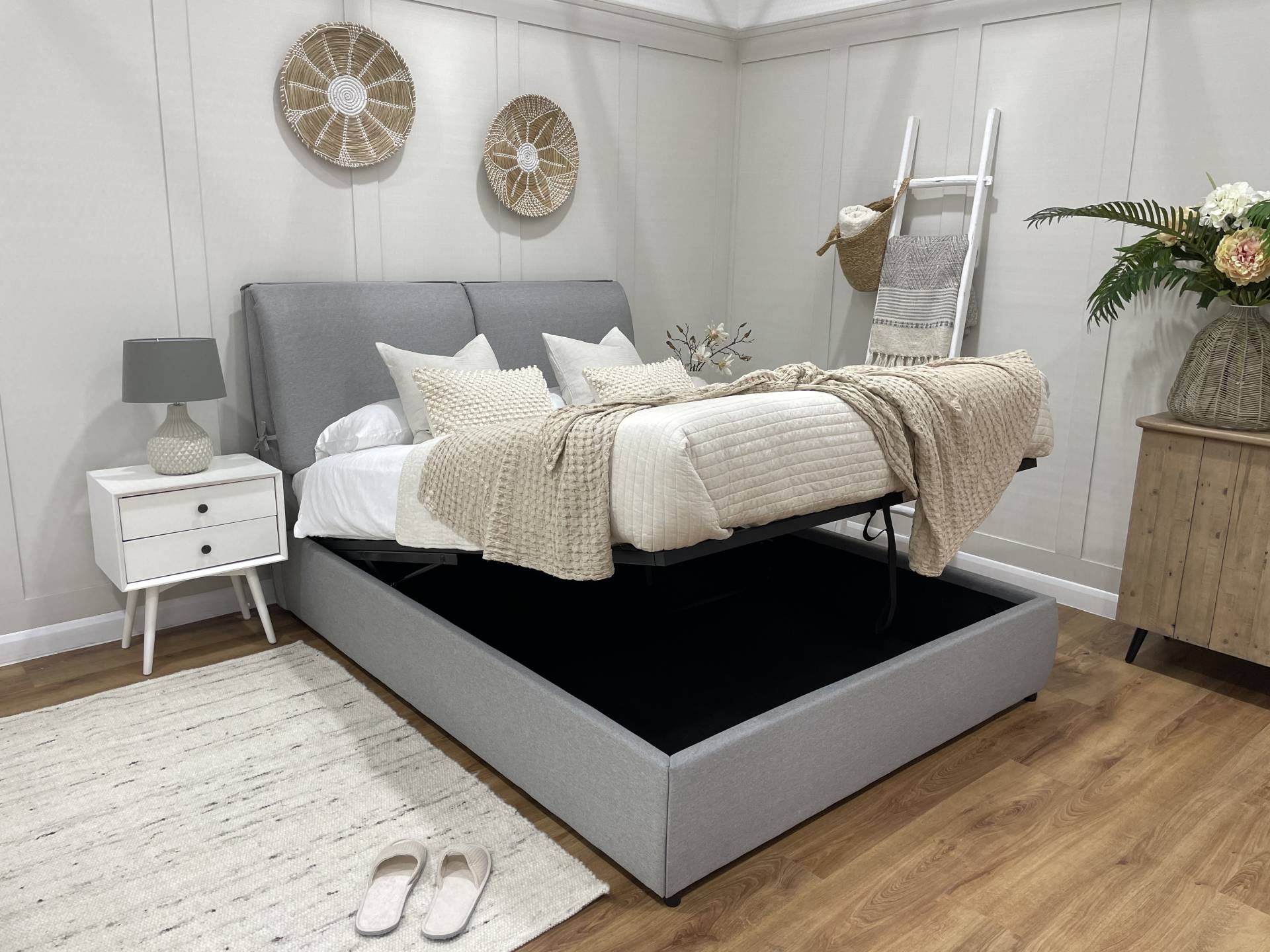 Grey linen ottoman bed showing the lift up storage space