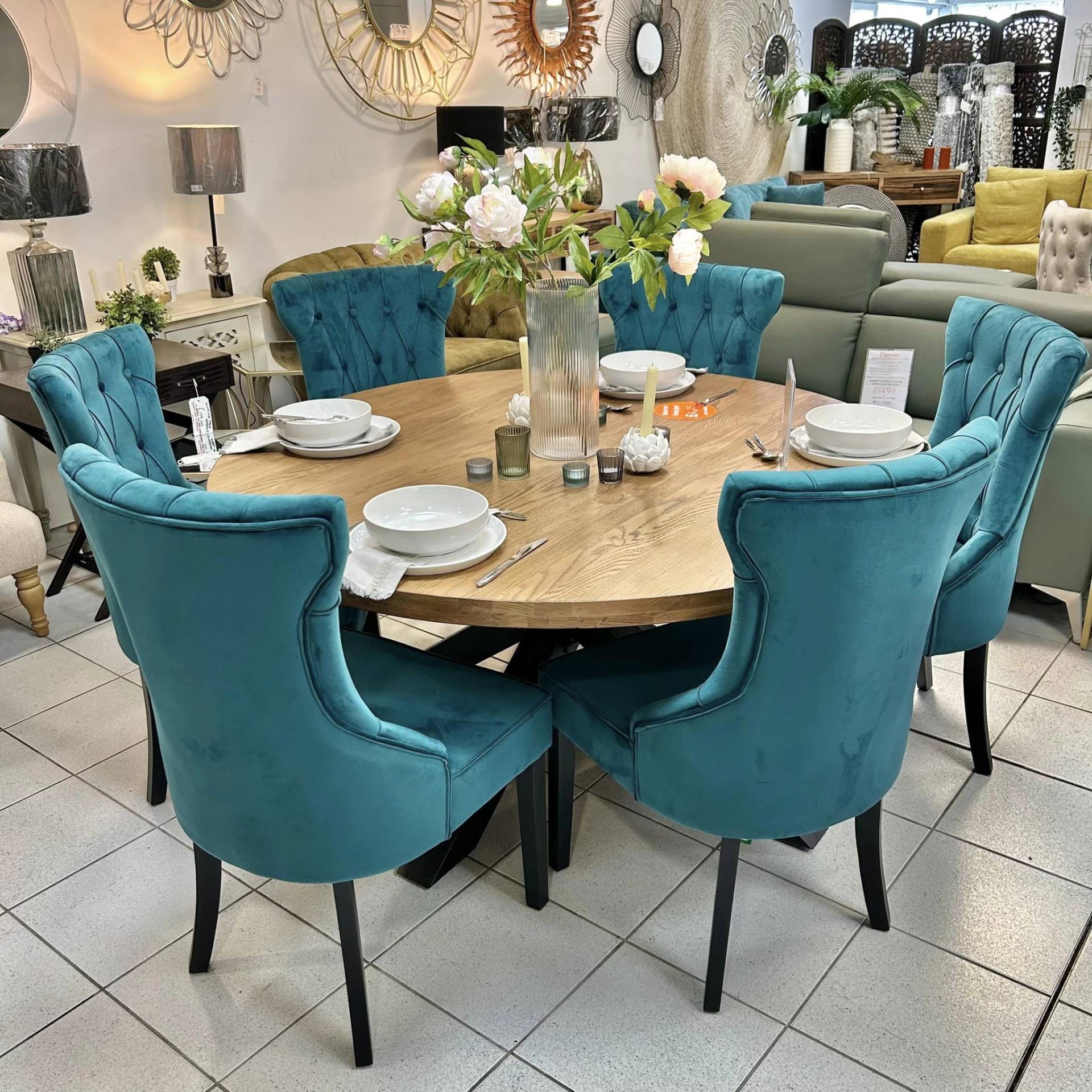 Oak round dining table and teal chairs set at Furniture Outlet Stores