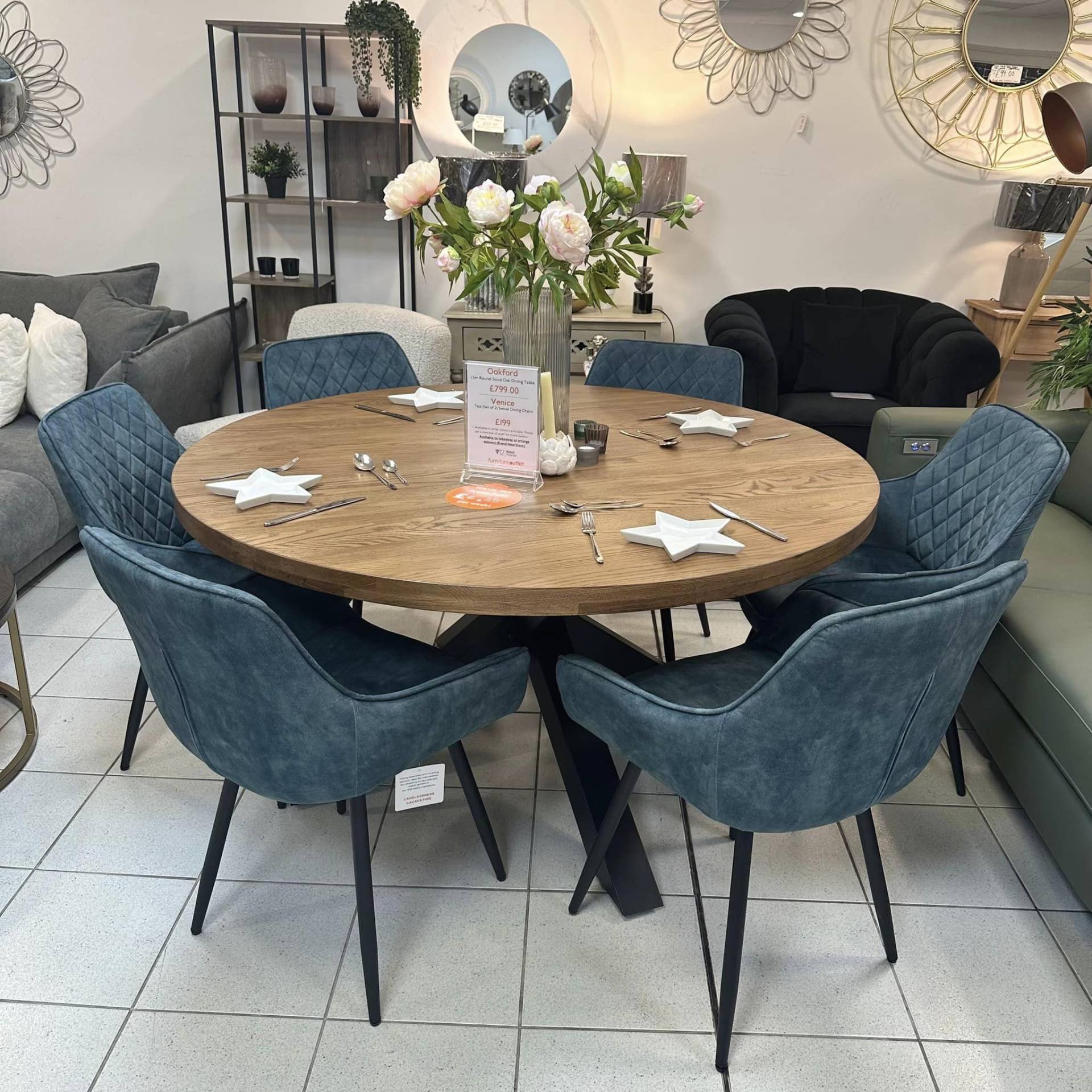 Teal swivel chairs with oak wood round dining table