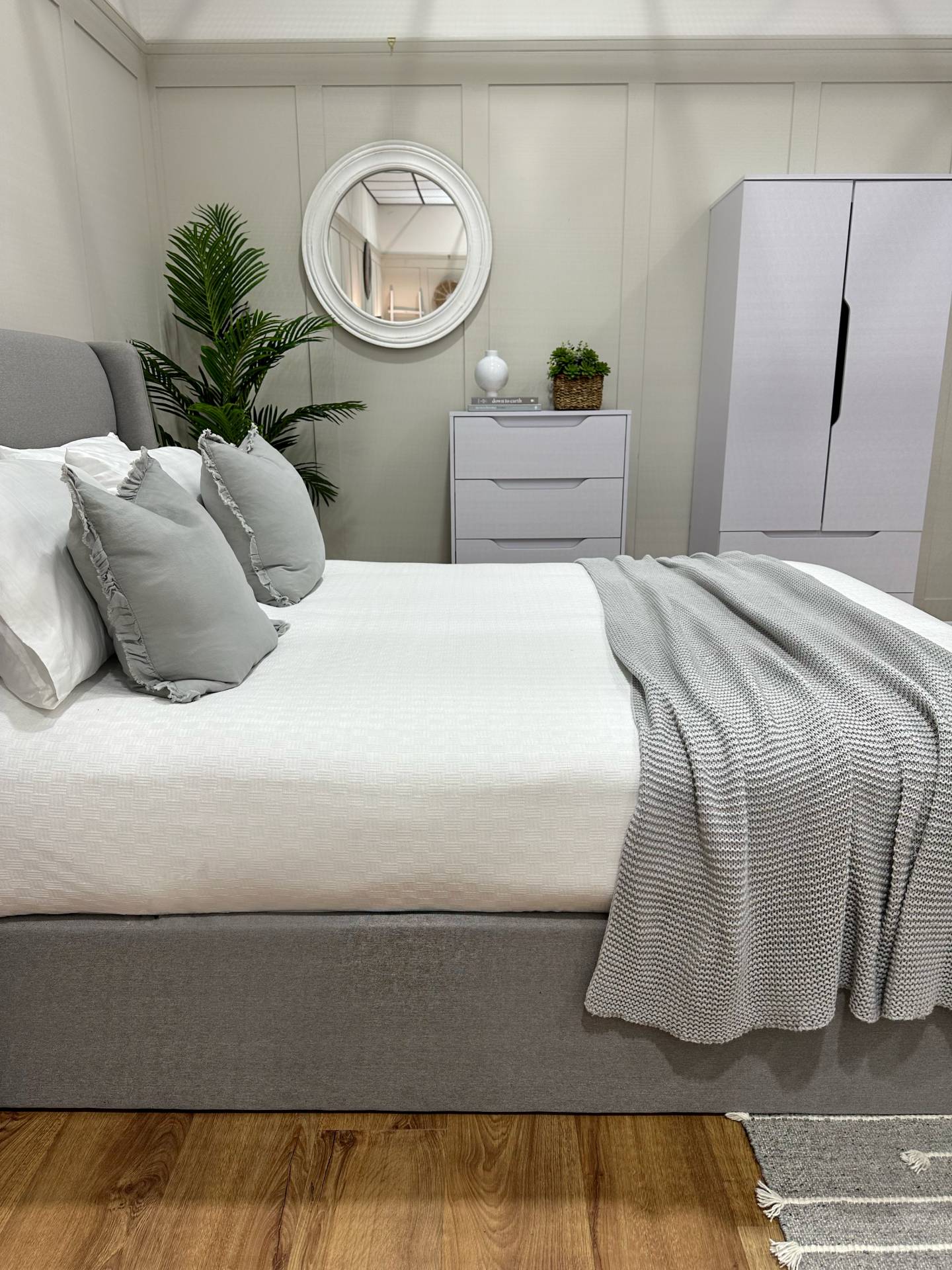 Grey ottoman bed and bedside storage units