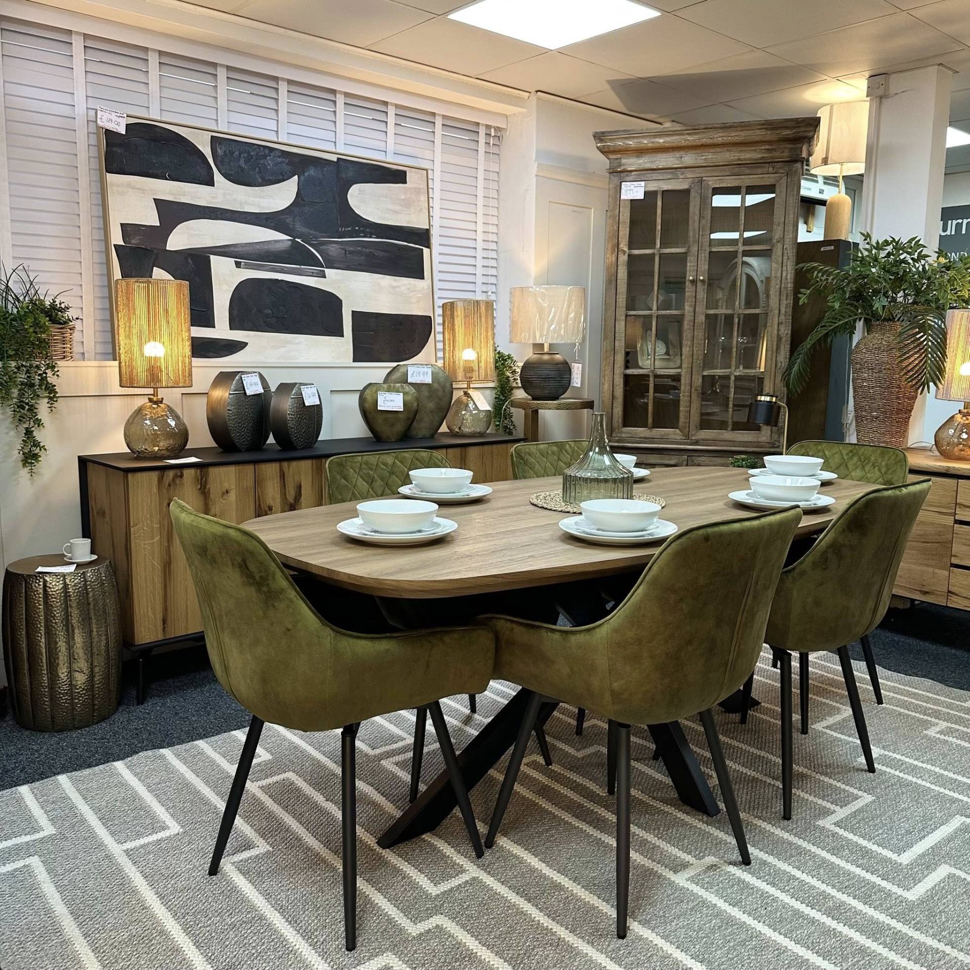 Florian oak effect dining table and Venice olive velvet swivel chairs. A sleek, earthy set at Furniture Outlet Wickford