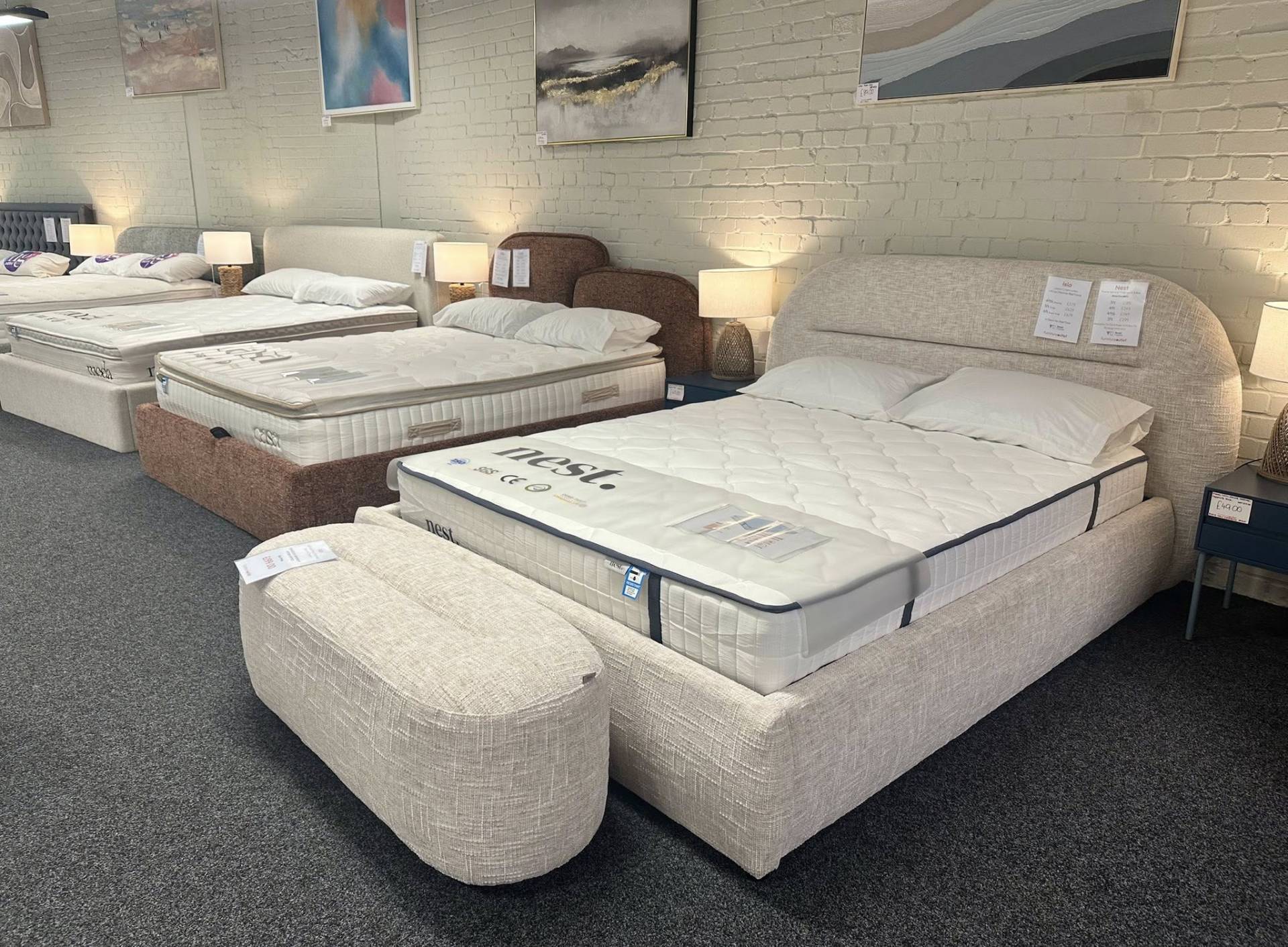 Cream linen Isla ottoman storage bed. Luxury lift up frame at our Furniture Outlet store