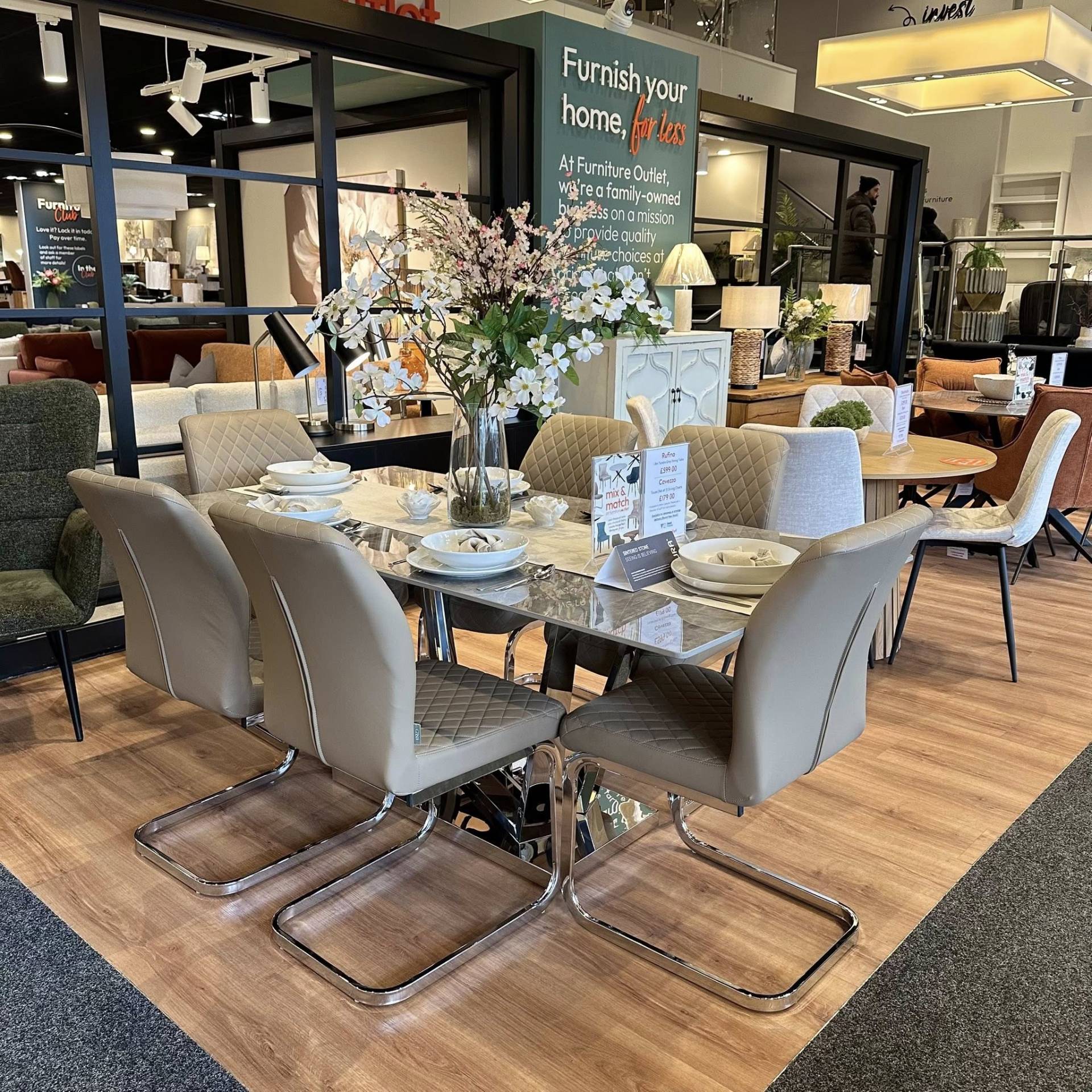 Rufino grey stone dining table and Cavezzo taupe chairs at the Furniture Outlet Charlton store