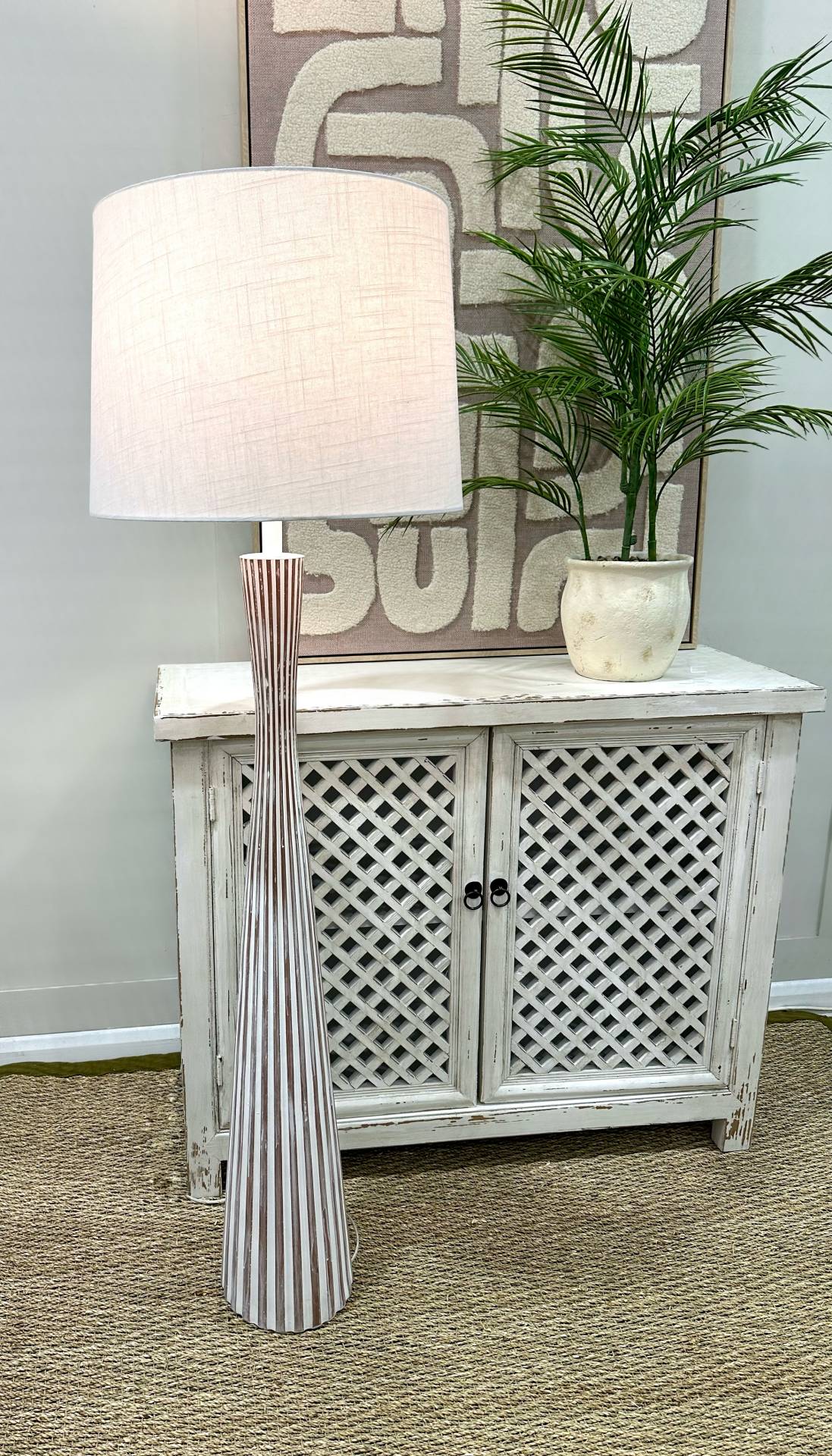 Floor lamp next to shabby chic cabinet