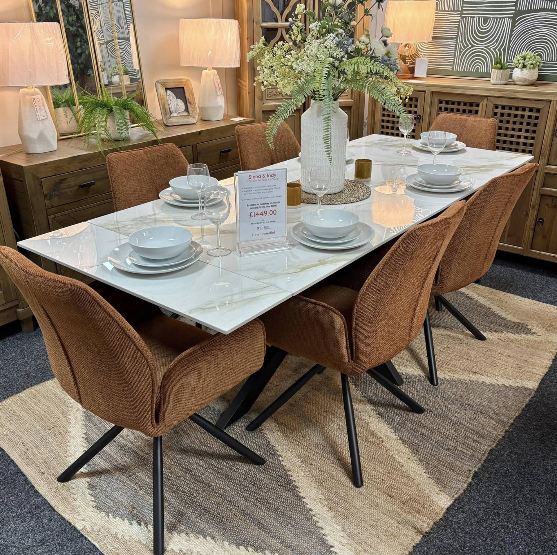 Sintered stone dining table with burnt orange swivel dining chairs