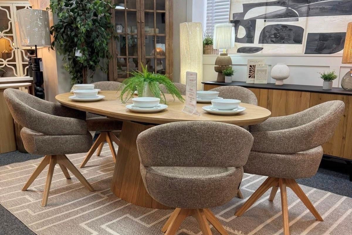 Modern dining room with Lusso Toffee swivel dining chairs around an Allegra oval oak dining table, styled with neutral decor