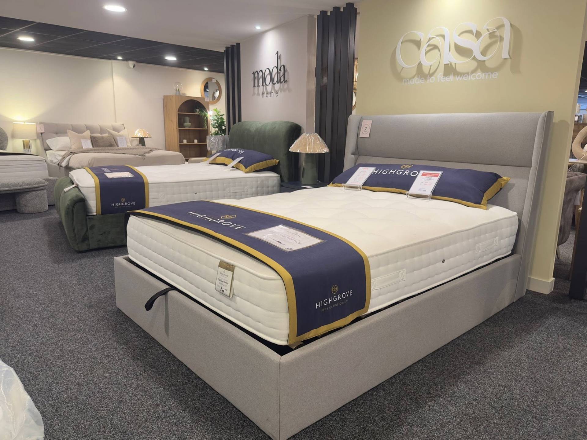 Charlton showroom display of ottoman storage beds with Highgrove mattresses and modern upholstered frames